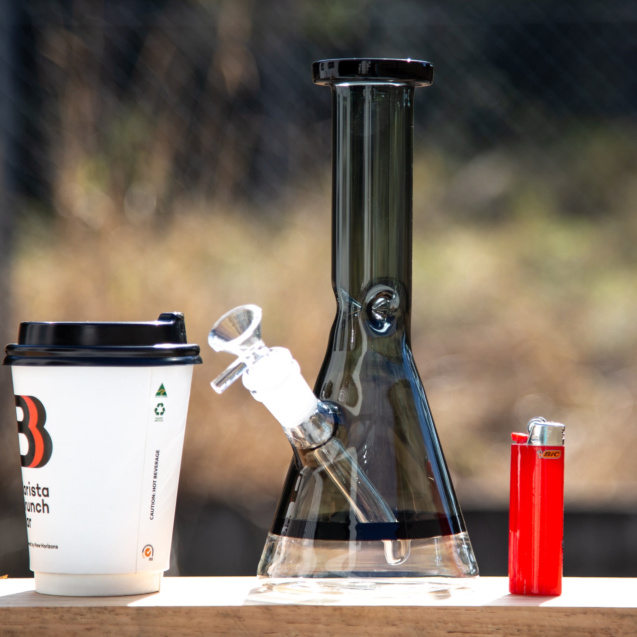 Colourful small beaker bong with down stem and cone piece.