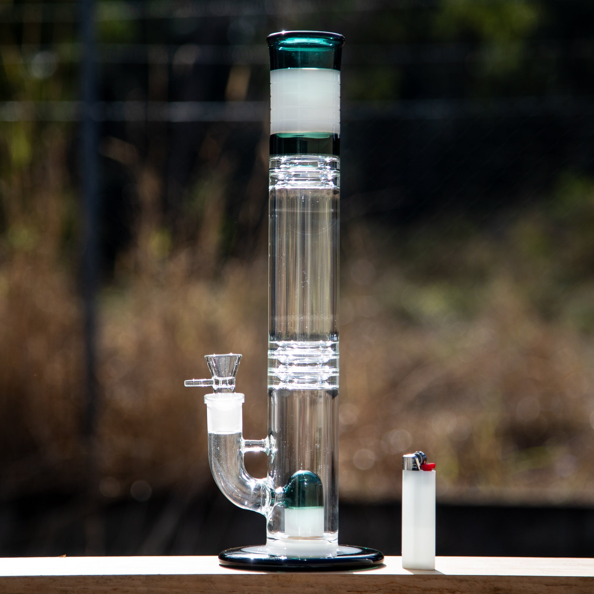 Straight glass bong with cap style perc and stemless 18mm joint.