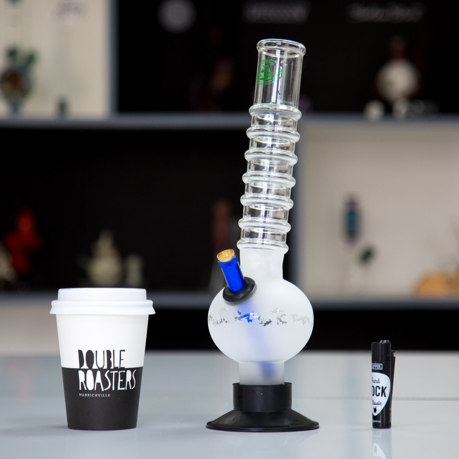 Frosted glass Agung bong with intricate design.