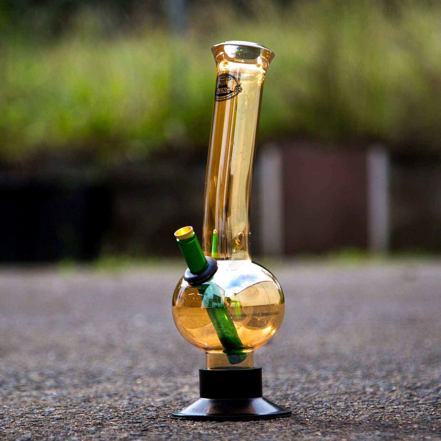 Outdoor shot of Agung gold bubble bottom Aussie style glass bong.