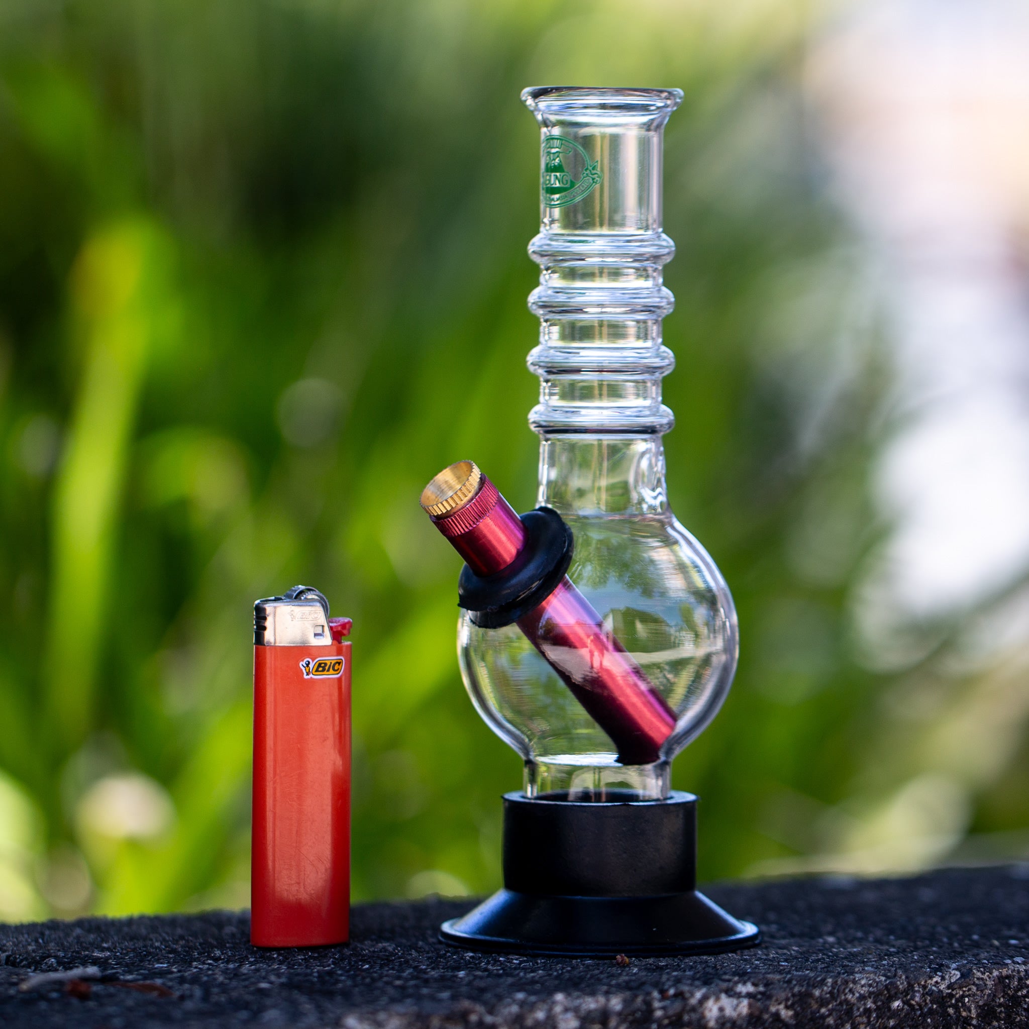 Agung handy bong sitting outside in the sun.