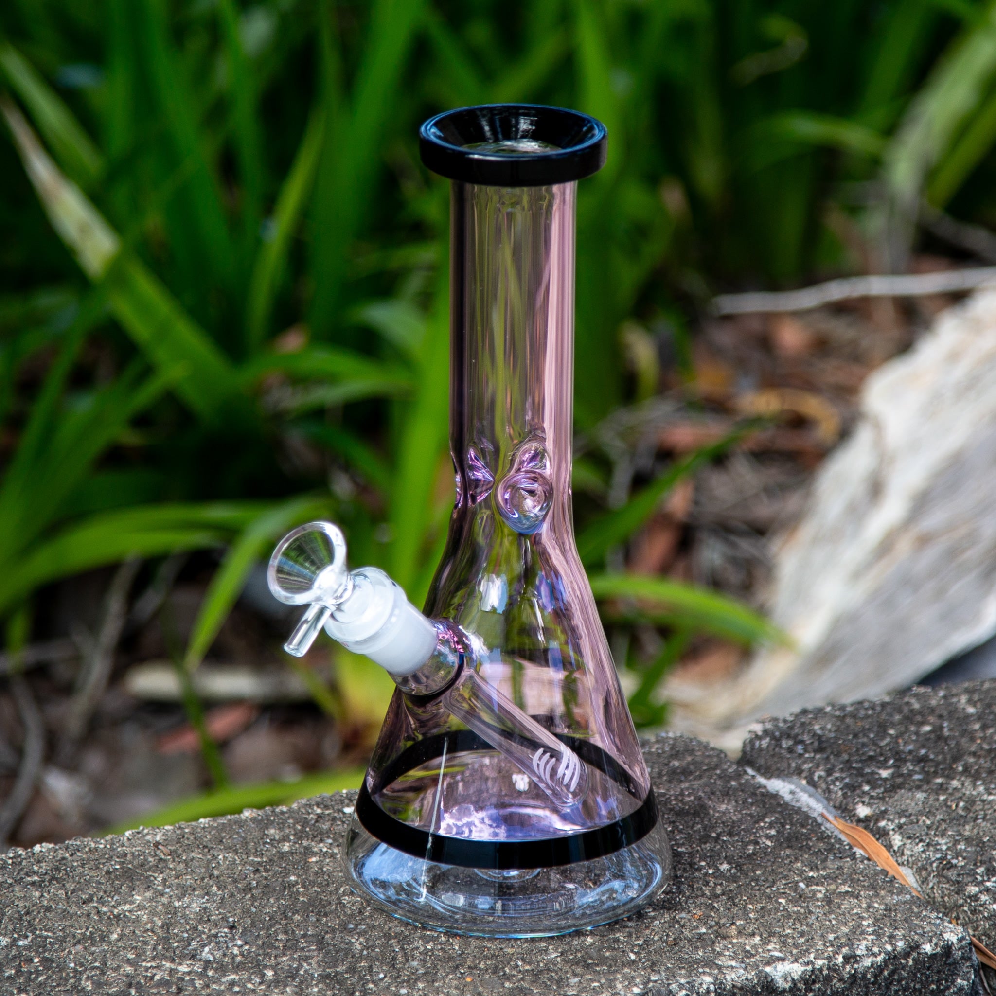 Colourful small beaker bong with down stem and cone piece.