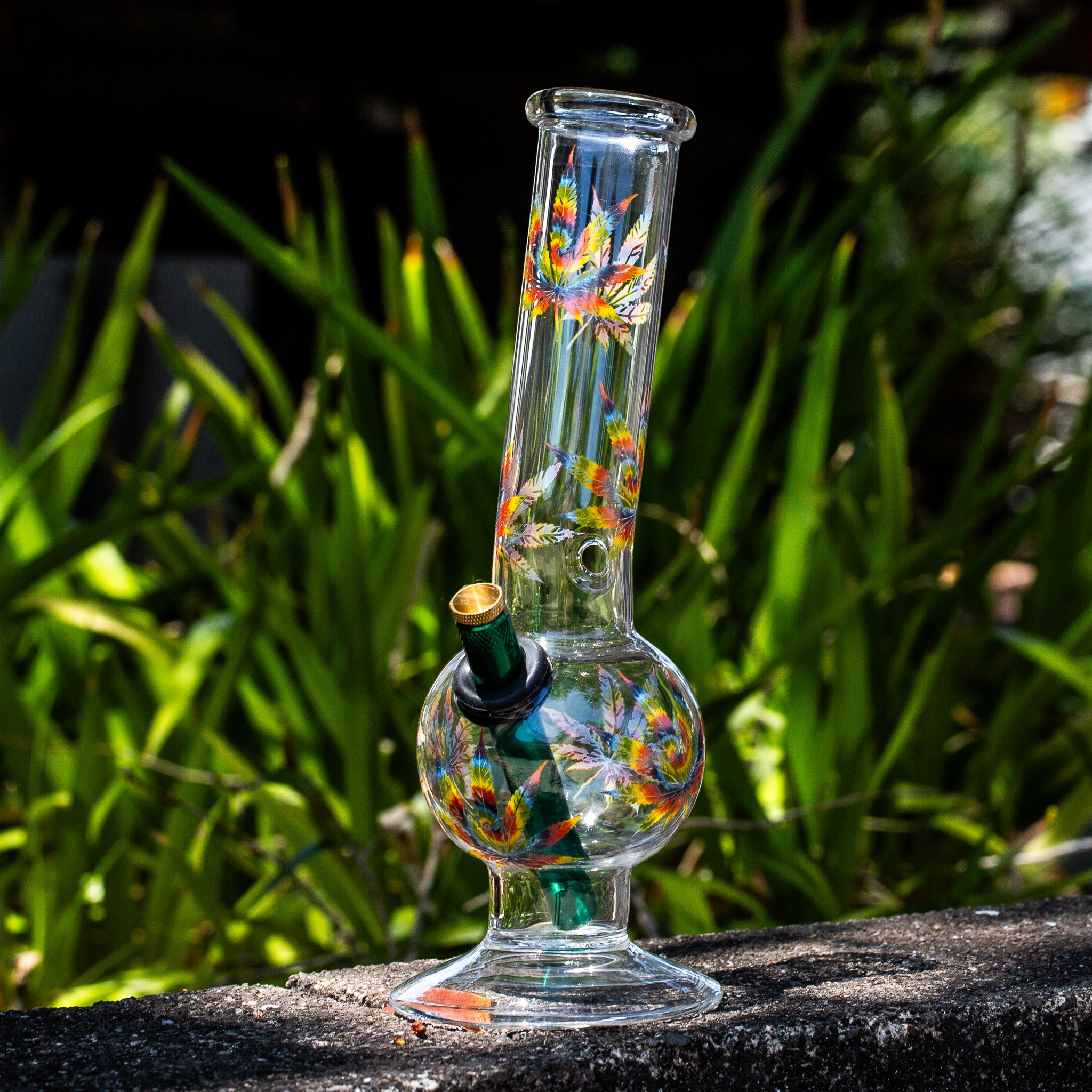 Glass Aussie style bong with marijuana leaf decals.