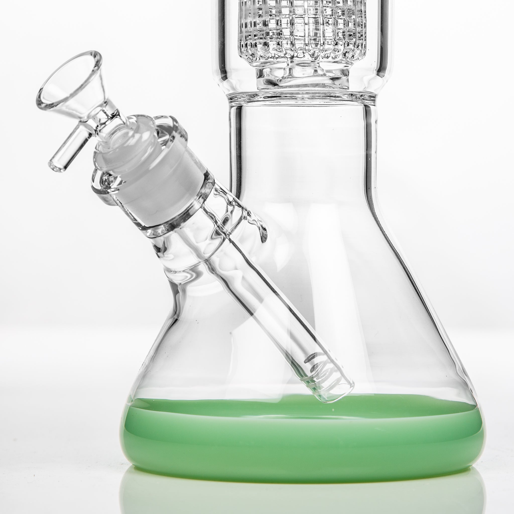 The base of a glass beaker bong showing the diffused down stem and cone piece as well as the percolator for diffusion.